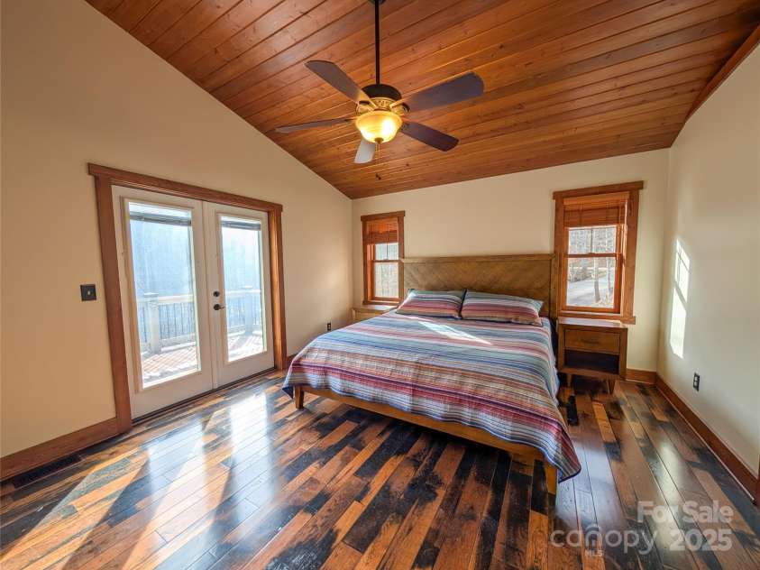 13 Miners Trace Road, Burnsville, NC 28714.  MLS# CAR4206928, YatesRealty ID 13994. Primary bedroom offers access to front deck, walk-in closet & bathroom.