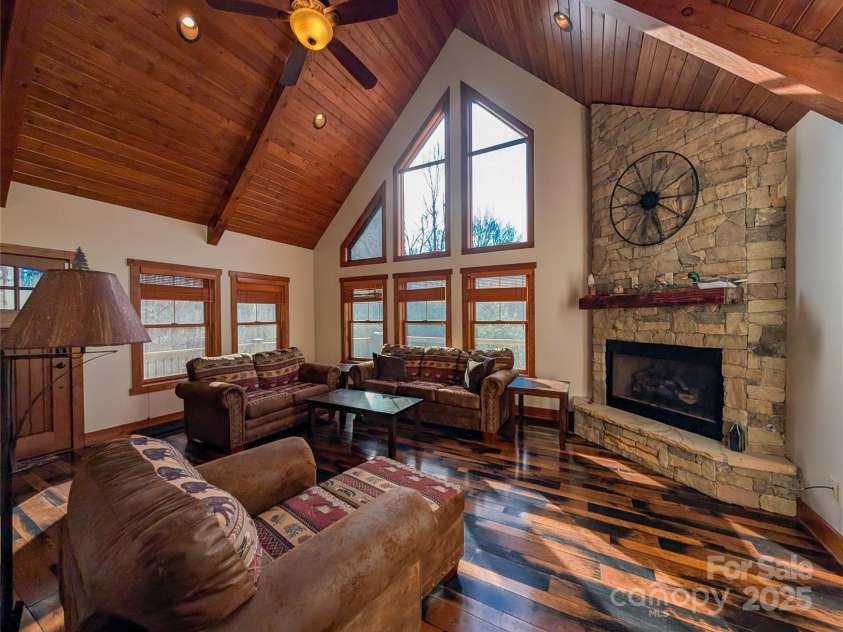 13 Miners Trace Road, Burnsville, NC 28714.  MLS# CAR4206928, YatesRealty ID 13994. The seamless blend of rustic and modern elements creates an atmosphere of sophisticated comfort, a space designed for both relaxation and lively gatherings.
