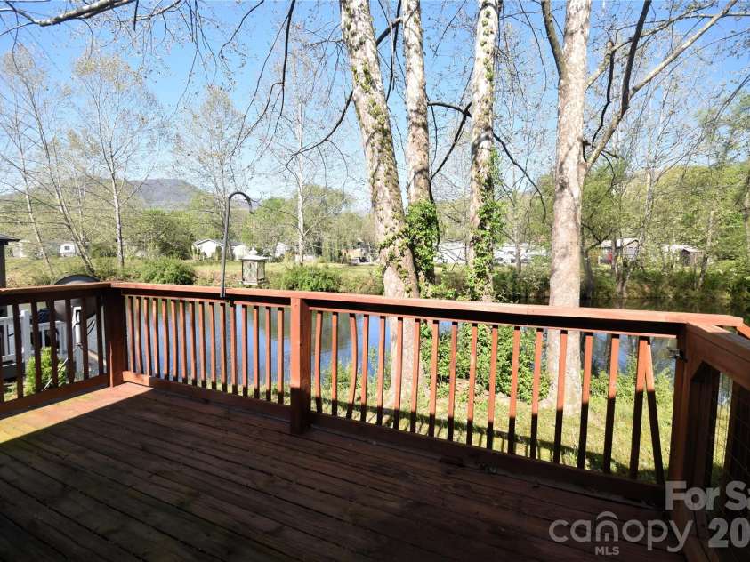 124 Pike Point, Waynesville, NC 28785.  MLS# CAR4371521, YatesRealty ID 13996. Deck on the rear overlooks the pond