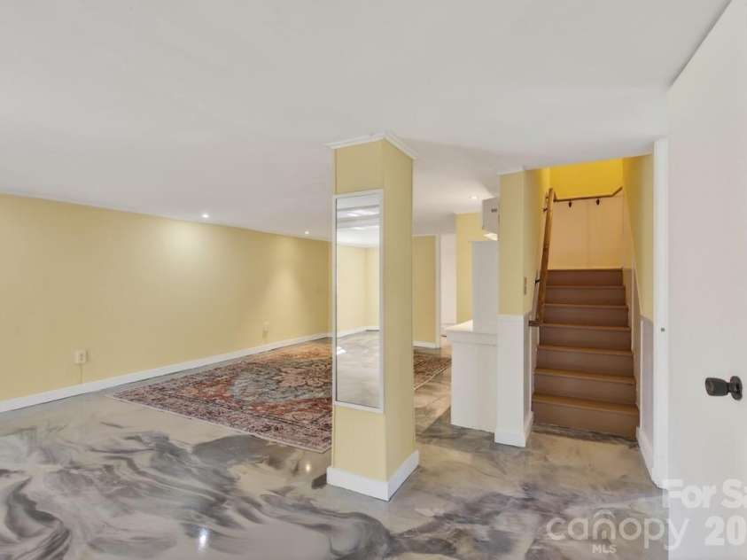 95 Whitney Avenue, Tryon, NC 28782.  MLS# CAR4354640, YatesRealty ID 14002. Basement den