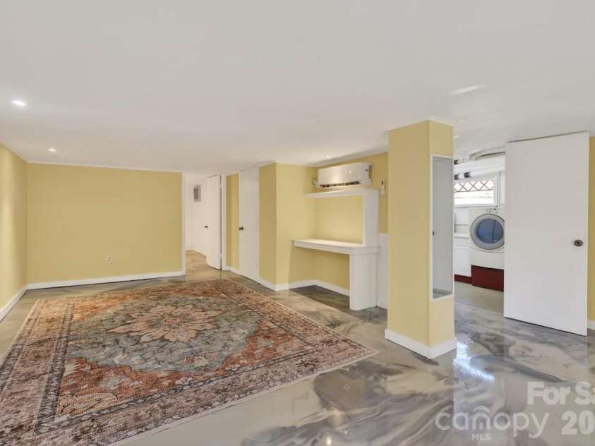 95 Whitney Avenue, Tryon, NC 28782.  MLS# CAR4354640, YatesRealty ID 14002. Basement den looking into laundry room