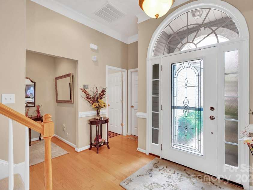 141 Ivy Creek Lane, Mooresville, NC 28115.  MLS# CAR4246190, YatesRealty ID 14012. Foyer area with access to the primary bedroom, 1/2 bath, laundry room and garage access