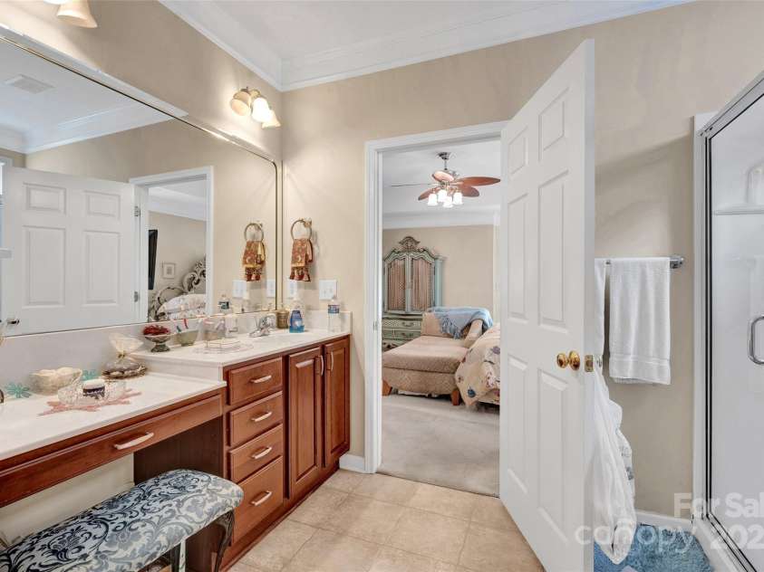 141 Ivy Creek Lane, Mooresville, NC 28115.  MLS# CAR4246190, YatesRealty ID 14012. Primary bathroom with vanity area, shower stall, huge walk in closet and a second oversized closet for clothes or linens