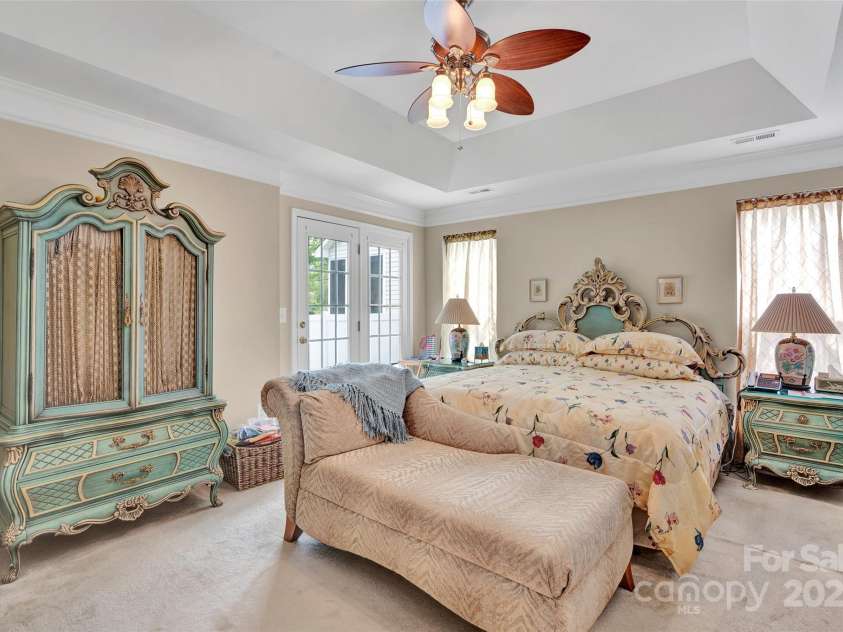 141 Ivy Creek Lane, Mooresville, NC 28115.  MLS# CAR4246190, YatesRealty ID 14012. Primary suite on the main level with tray ceilings and access to the back covered patio