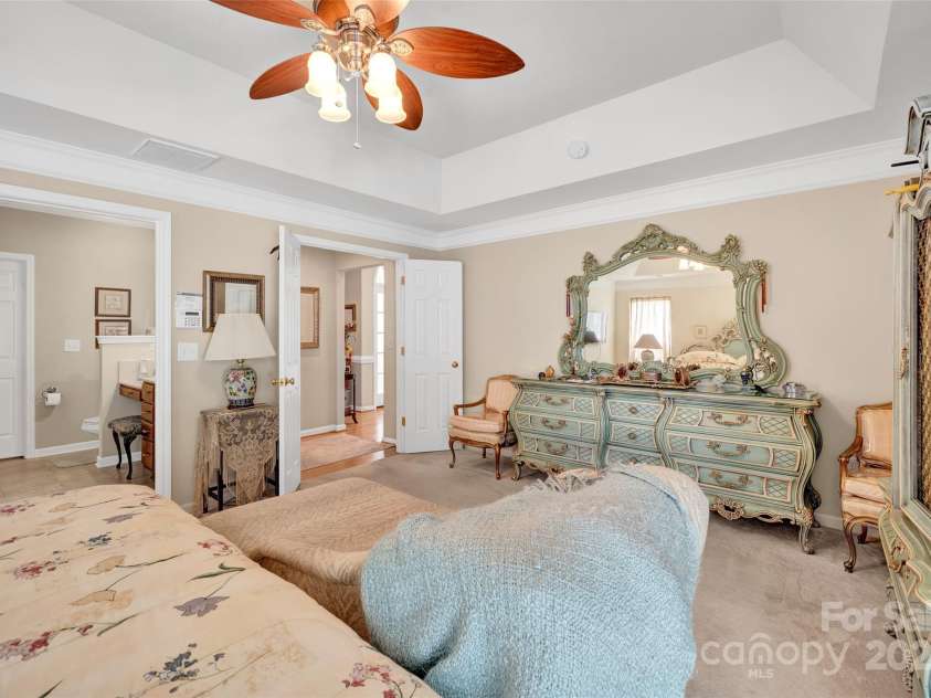 141 Ivy Creek Lane, Mooresville, NC 28115.  MLS# CAR4246190, YatesRealty ID 14012. Primary suite with double door entry, tray ceiling and primary bath entry