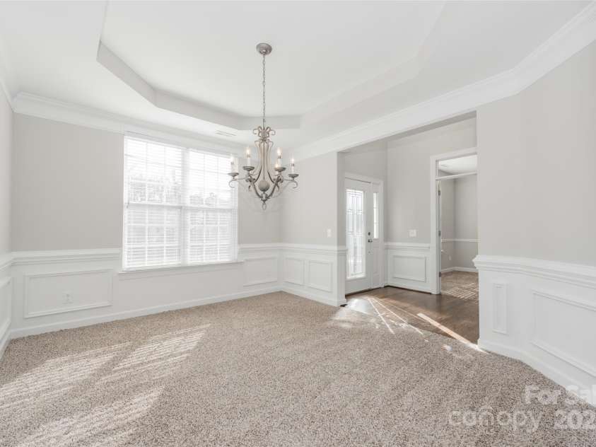 10008 King George Lane, Waxhaw, NC 28173.  MLS# CAR4257017, YatesRealty ID 14025. Radiant and airy, this sun-filled dining room with an elegant tray ceiling offers the perfect setting for memorable gatherings and entertaining