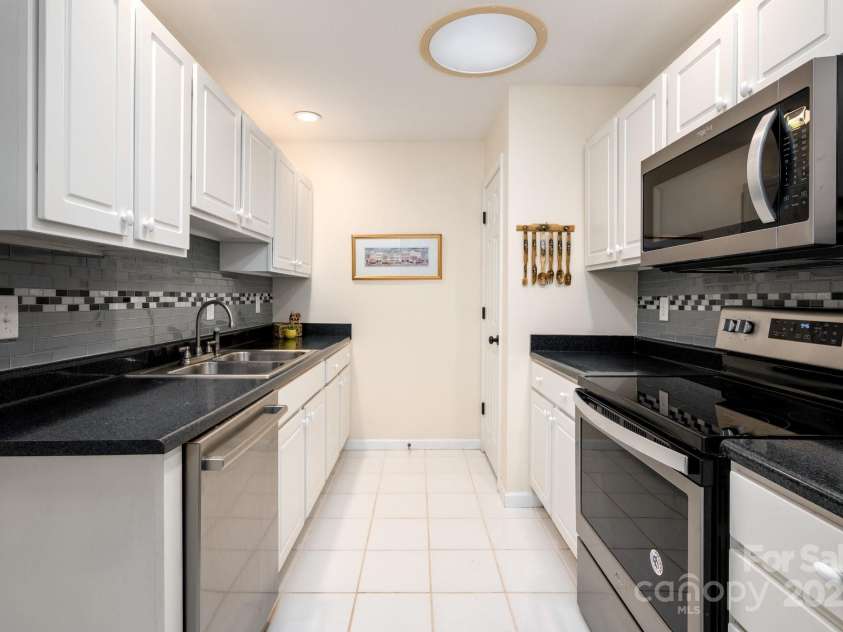 206 Carrington Place, Arden, NC 28704.  MLS# CAR4249528, YatesRealty ID 14027. Galley kitchen with modern finishes