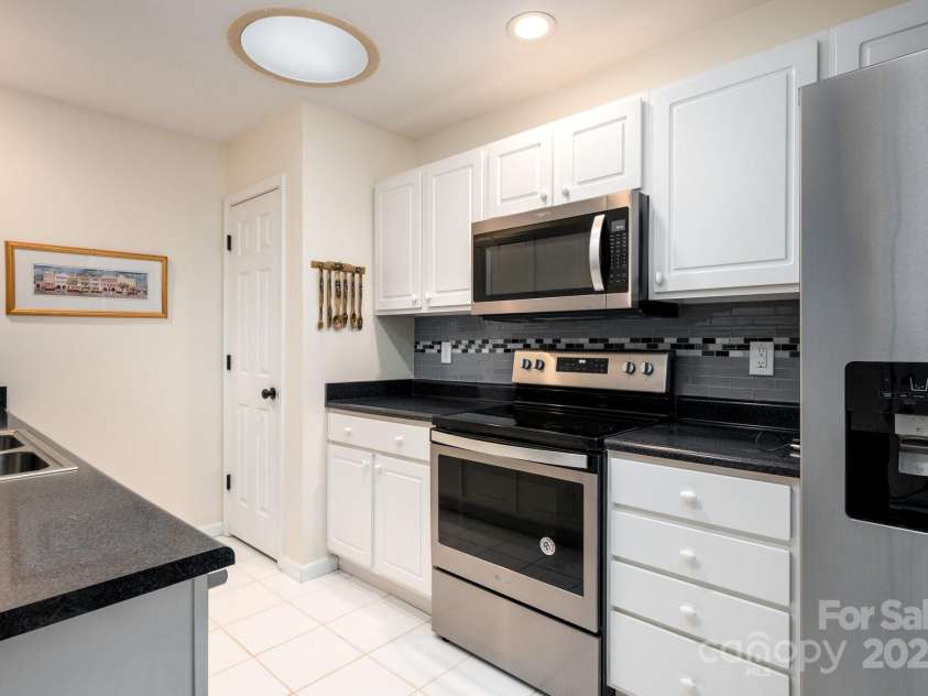 206 Carrington Place, Arden, NC 28704.  MLS# CAR4249528, YatesRealty ID 14027. Stainless appliances and updated lighting