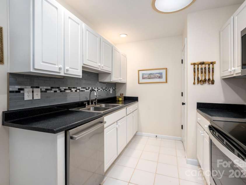 206 Carrington Place, Arden, NC 28704.  MLS# CAR4249528, YatesRealty ID 14027. Tile flooring and sleek counters