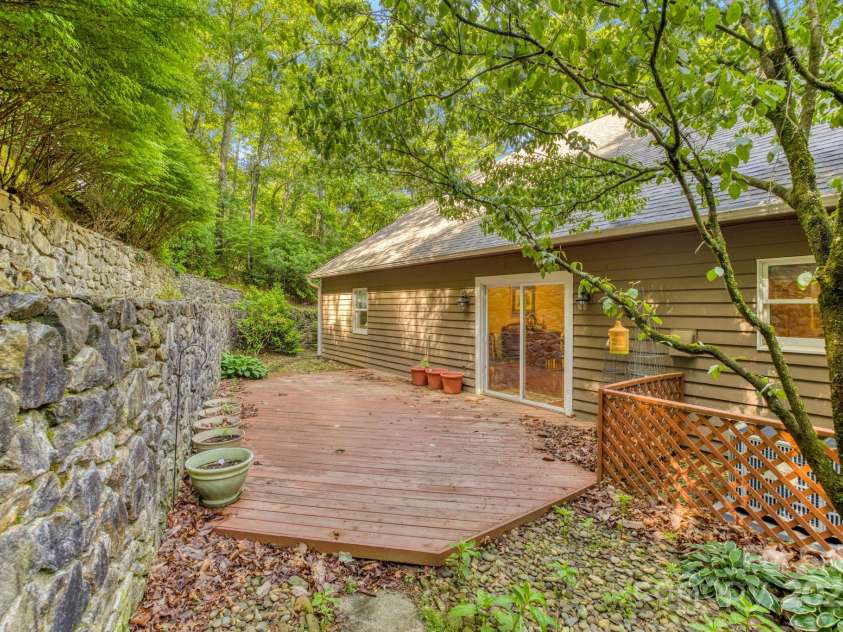 16 Cedar Drive, Mills River, NC 28759.  MLS# CAR4148510, YatesRealty ID 14036. Back Stone Retaining Wall & Deck