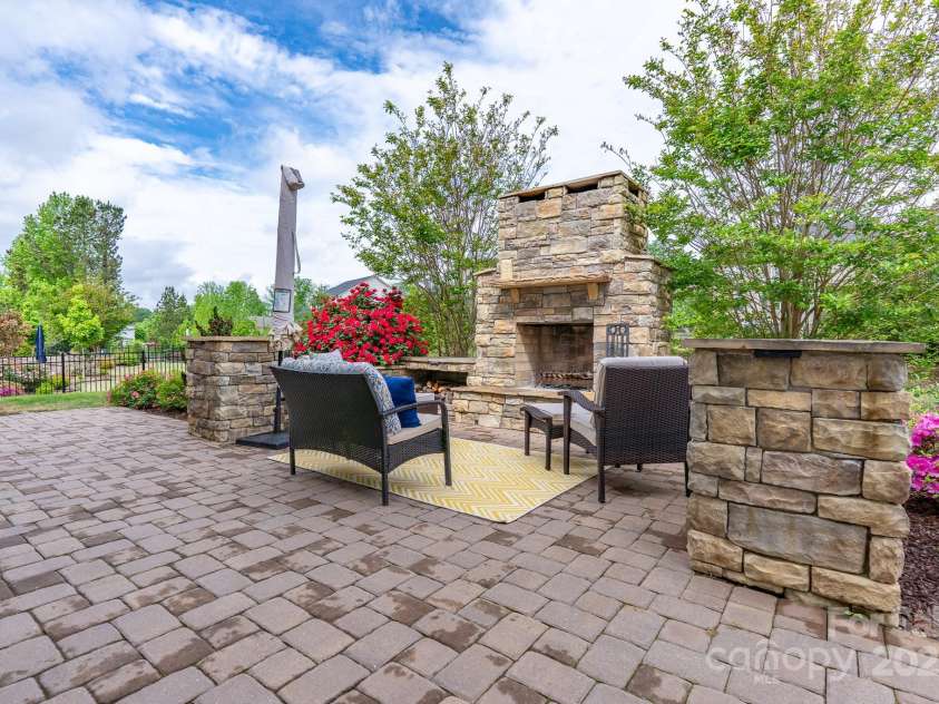 16711 Monocacy Boulevard, Huntersville, NC 28078.  MLS# CAR4249160, YatesRealty ID 14044. Outdoor living area with custom fireplace and paver patio