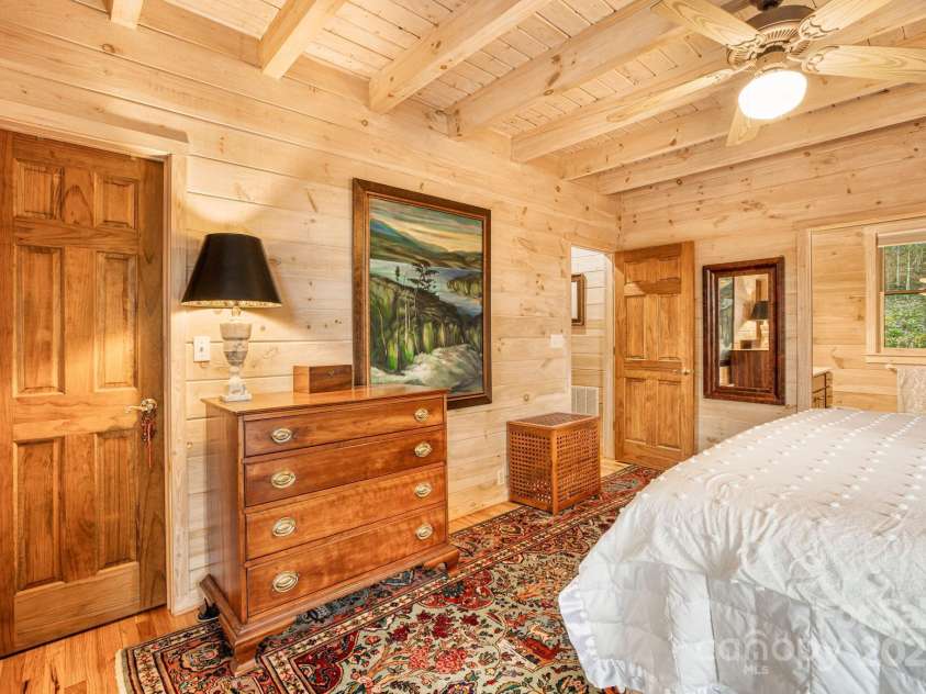 60 Laurel Lane, Mars Hill, NC 28754.  MLS# CAR4256396, YatesRealty ID 14054. Main level primary bedroom