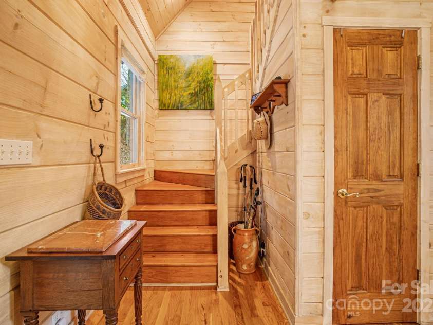 60 Laurel Lane, Mars Hill, NC 28754.  MLS# CAR4256396, YatesRealty ID 14054. Stairs lead to the upper level guest suites & loft.
