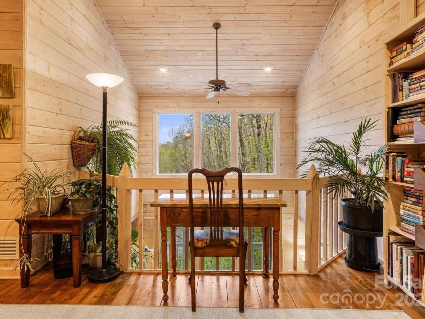 60 Laurel Lane, Mars Hill, NC 28754.  MLS# CAR4256396, YatesRealty ID 14054. Wall of windows allows the outdoors, in.