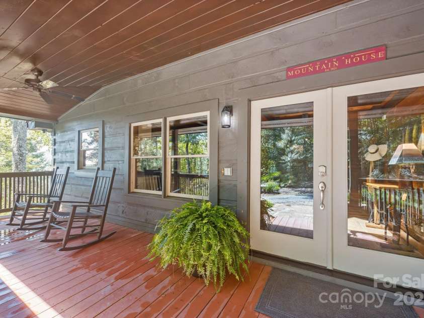 670 Barber Road, Zirconia, NC 28790.  MLS# CAR4293053, YatesRealty ID 1406. Rocking chair front porch
