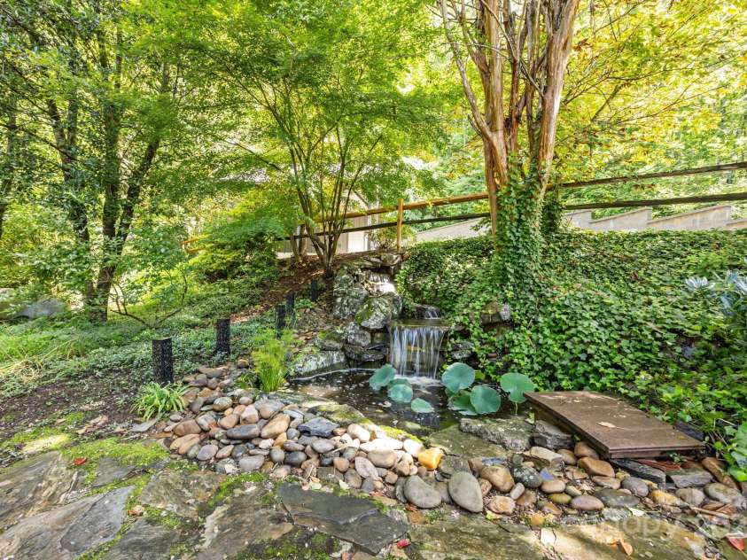 670 Barber Road, Zirconia, NC 28790.  MLS# CAR4293053, YatesRealty ID 1406. Upper water feature with hillside falls