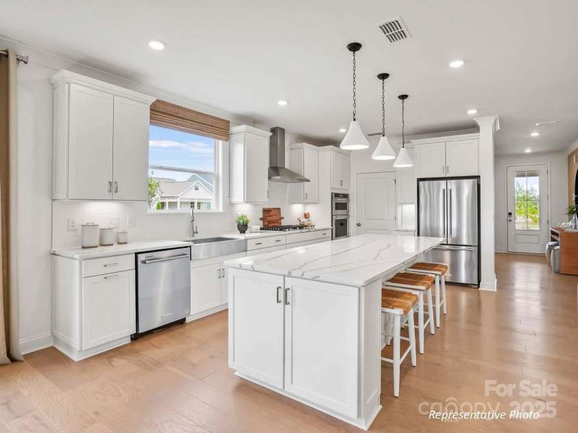 1022 Paddlers Way, Belmont, NC 28012.  MLS# CAR4260397, YatesRealty ID 14071. Luxurious gourmet kitchen with gas cooktop, oversized island, and large walk-in pantry