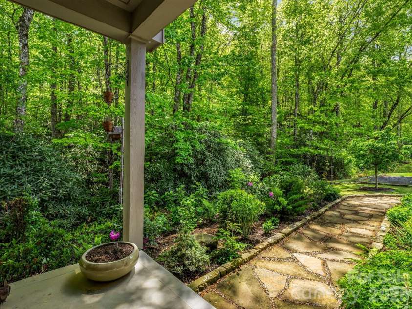 29 Stonehollow Lane, Brevard, NC 28712.  MLS# CAR4347760, YatesRealty ID 14076. Looking out front door at epoxy pathway and privacy