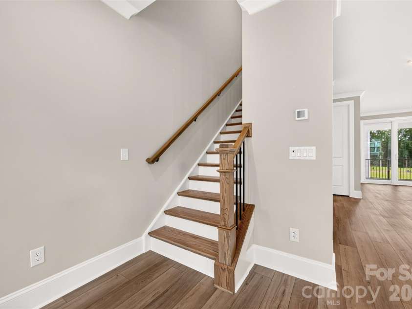 6012 Yellow Buckeye Drive, Charlotte, NC 28277.  MLS# CAR4396146, YatesRealty ID 14085. Second floor oak box stairs with open rails