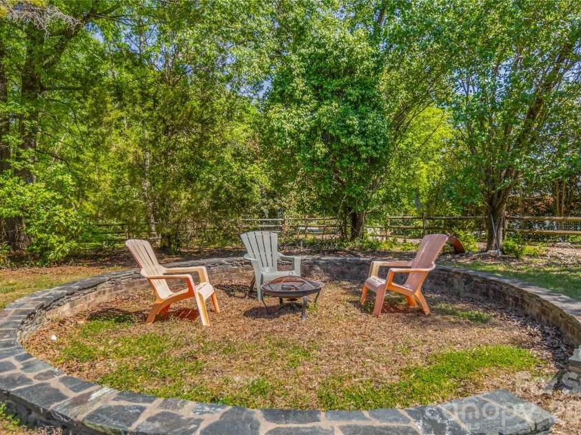 6208 Highview Road, Matthews, NC 28104.  MLS# CAR4363062, YatesRealty ID 14093. Great fire pit area, garden, sand box....