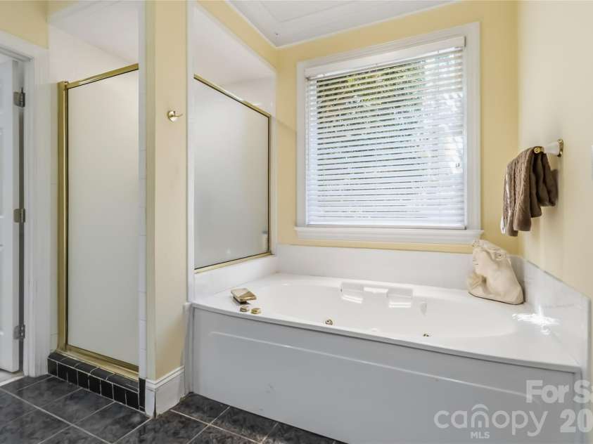 6208 Highview Road, Matthews, NC 28104.  MLS# CAR4363062, YatesRealty ID 14093. Separate tub and tiled shower