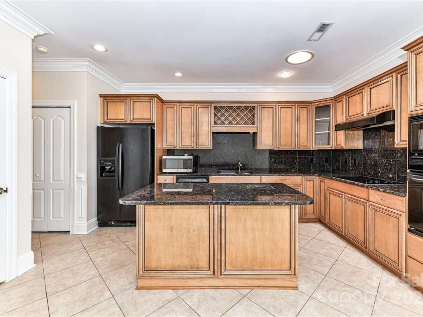 178 Harper Lee Street, Davidson, NC 28036.  MLS# CAR4232984, YatesRealty ID 14113. Spacious Kitchen with granite countertops and backsplash