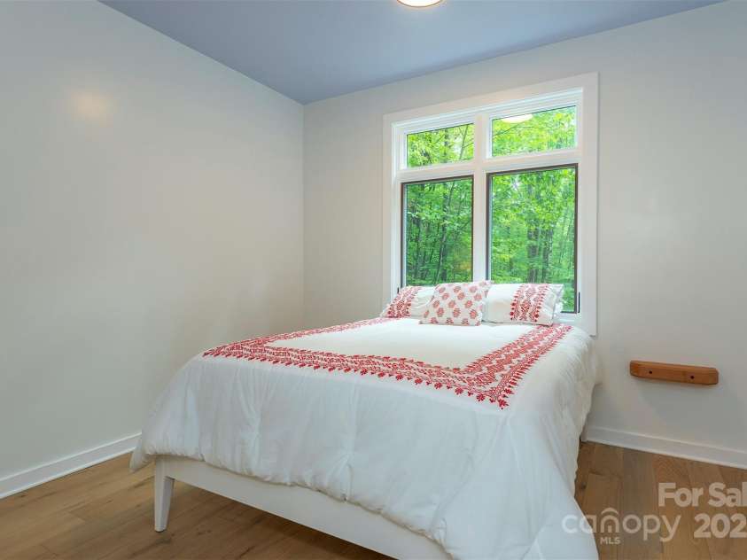 401 Winterle Road, Lake Lure, NC 28746.  MLS# CAR4254959, YatesRealty ID 14115. Primary bedroom is bright and open.