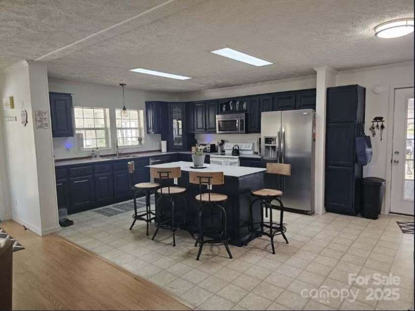 1597 Cleghorn Mill Road, Rutherfordton, NC 28139.  MLS# CAR4213254, YatesRealty ID 1413. Freshly painted modern kitchen. Breakfast bar, tons of storage and counter space. 