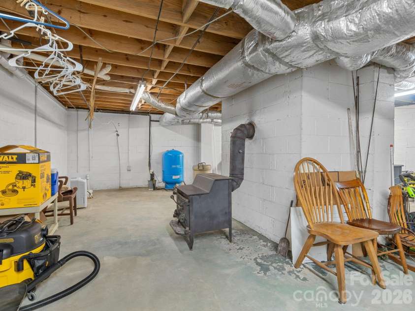 405 Loop Road, Campobello, SC 29322.  MLS# CAR4370899, YatesRealty ID 14181. Unfinished basement has a wood burning stove