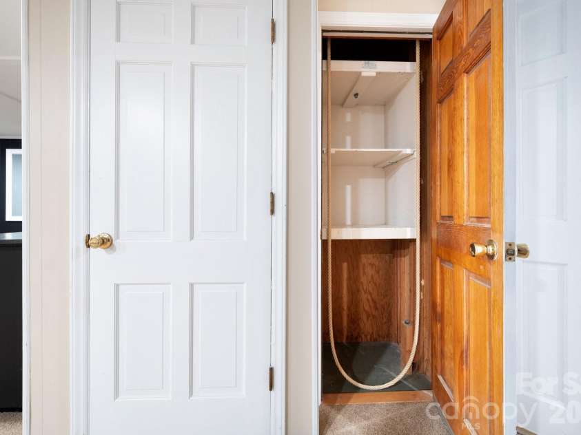 200 Allen Mountain Drive, Black Mountain, NC 28711.  MLS# CAR4329989, YatesRealty ID 14185. Dumbwaiter location on the lower level going up to the kitchen. Walk your groceries from the garage to the Dumbwaiter and easily get them up to the kitchen. 