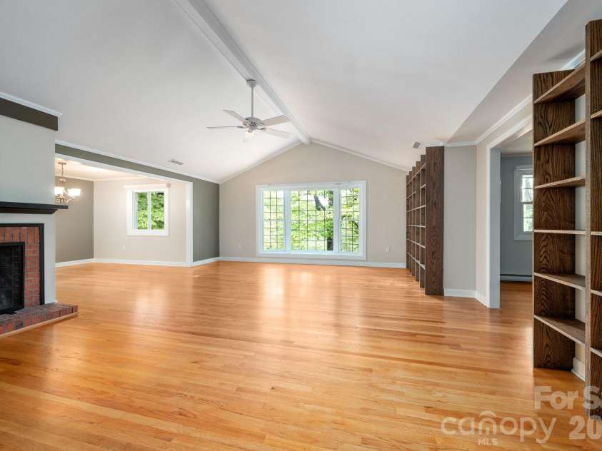 200 Allen Mountain Drive, Black Mountain, NC 28711.  MLS# CAR4329989, YatesRealty ID 14185. Large open living space with vaulted ceiling, built on book shelves and is open to the dining area just off the kitchen. 
