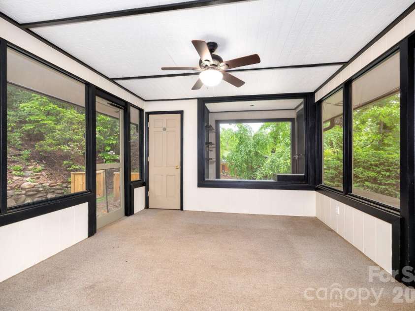 200 Allen Mountain Drive, Black Mountain, NC 28711.  MLS# CAR4329989, YatesRealty ID 14185. Lovely 3 season room located off the kitchen with access to the front and side yard. Great place to the fire pit. 