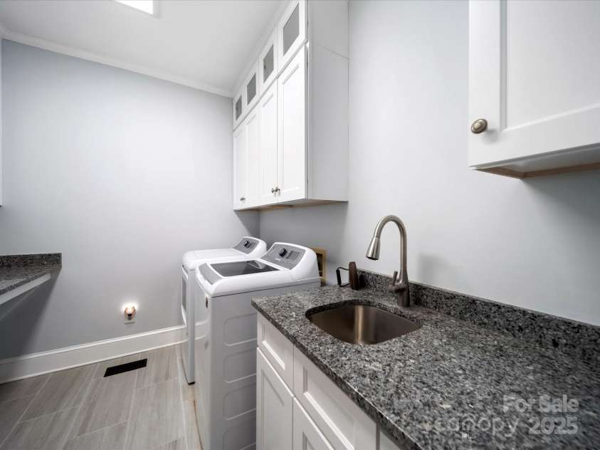 2217 Blue Bell Lane, Charlotte, NC 28270.  MLS# CAR4228161, YatesRealty ID 1419. Main level laundry room with sink
