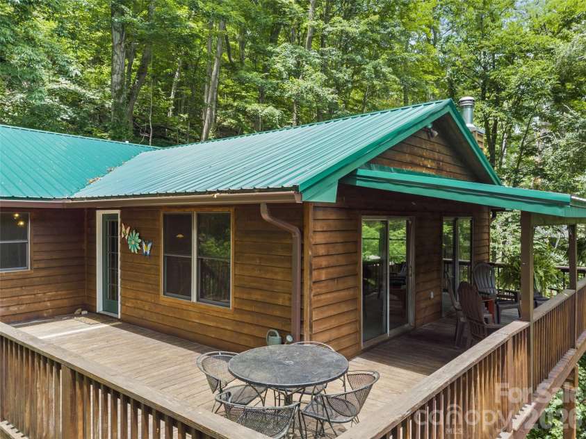 170 Mountain Farm Road, Burnsville, NC 28714.  MLS# CAR4362361, YatesRealty ID 14198. Large wrap-around partially covered deck