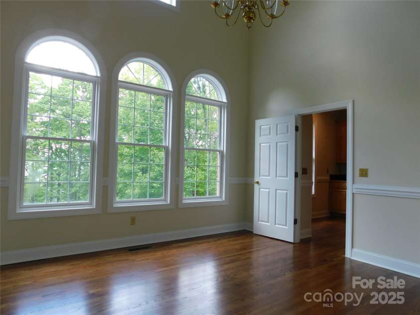 1064 Skye Drive, Pisgah Forest, NC 28768.  MLS# CAR4238839, YatesRealty ID 14202. Large arched windows in the dining room invites light in.