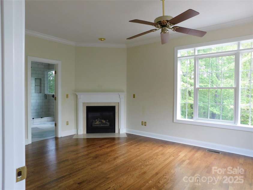 1064 Skye Drive, Pisgah Forest, NC 28768.  MLS# CAR4238839, YatesRealty ID 14202. Primary suite offers large windows and gas fireplace.