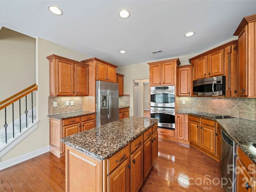 8734 Savannah Road, Harrisburg, NC 28075.  MLS# CAR4371873, YatesRealty ID 14204. Kitchen & Back Staircase