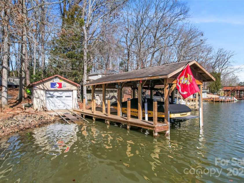 693 Emerald Shores Road, Mount Gilead, NC 27306.  MLS# CAR4225692, YatesRealty ID 14207. Grandfathered in dock and boat slip with lift.