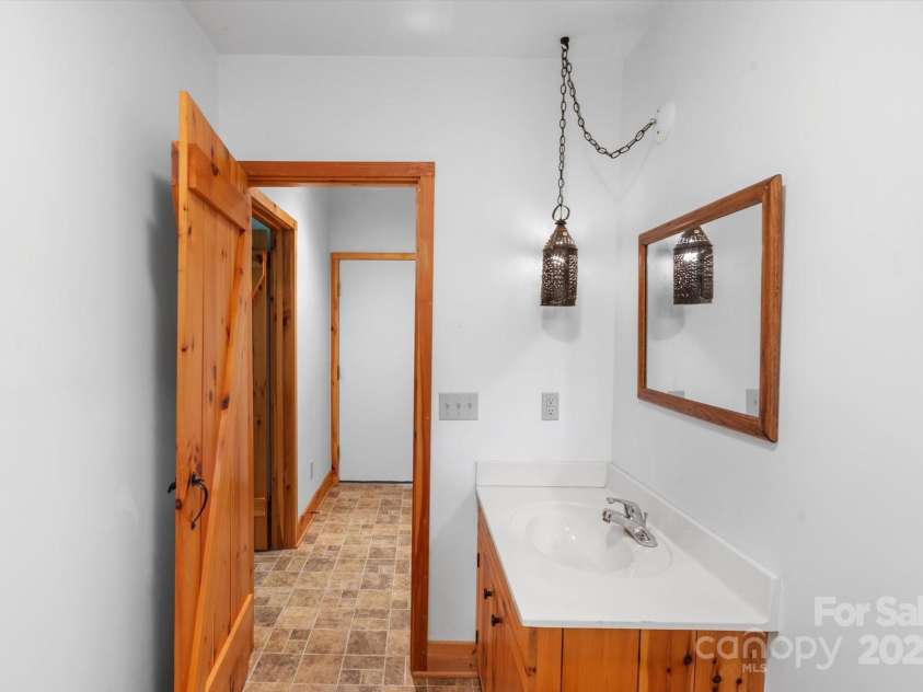 447 Cherokee Circle, Tryon, NC 28782.  MLS# CAR4315695, YatesRealty ID 14222. Primary Suite Bathroom in basement off stairs