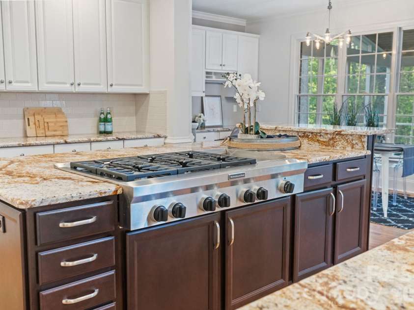 12644 Lahinch Court, Charlotte, NC 28277.  MLS# CAR4364918, YatesRealty ID 14234. Gas range with a wine cooler on the other side of the island.