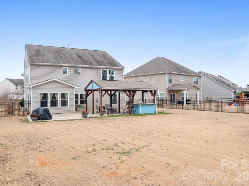 6308 Durango Way, Denver, NC 28037.  MLS# CAR4336580, YatesRealty ID 14236. Backyard Pavilion with patio, covered pavilion, two TVs, gas hookup for grill or fireplace, and bar. Perfect for entertaining.