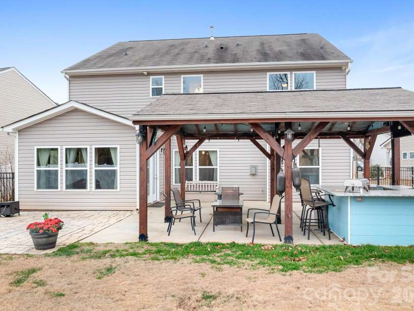 6308 Durango Way, Denver, NC 28037.  MLS# CAR4336580, YatesRealty ID 14236. Backyard Pavilion with patio, covered pavilion, two TVs, gas hookup for grill or fireplace, and bar. Perfect for entertaining.