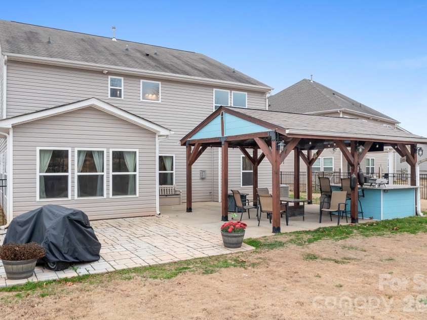 6308 Durango Way, Denver, NC 28037.  MLS# CAR4336580, YatesRealty ID 14236. Backyard Pavilion with patio, covered pavilion, two TVs, gas hookup for grill or fireplace, and bar. Perfect for entertaining.