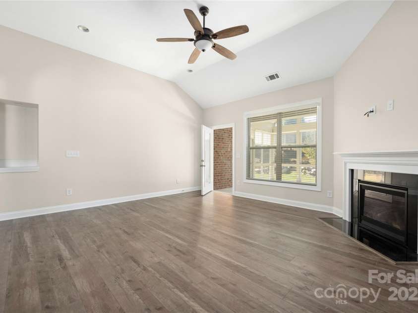 9026 Raven Top Drive, Mint Hill, NC 28227.  MLS# CAR4316455, YatesRealty ID 14246. Family room leads directly to the sunporch on the back of the property.