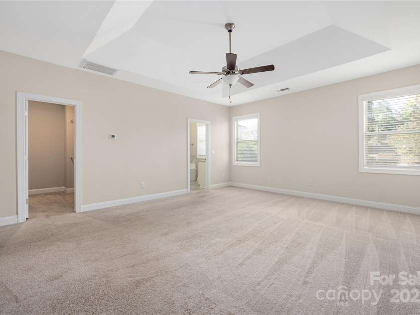 9026 Raven Top Drive, Mint Hill, NC 28227.  MLS# CAR4316455, YatesRealty ID 14246. Large primary bedroom on the main level.  Trey ceiling and walk in closet.