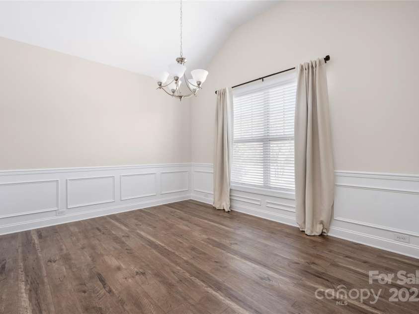 9026 Raven Top Drive, Mint Hill, NC 28227.  MLS# CAR4316455, YatesRealty ID 14246. Last dinig room view showing custom molding and tall vaulted ceiling.