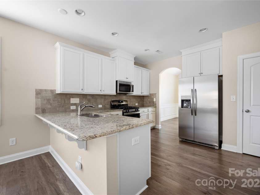 9026 Raven Top Drive, Mint Hill, NC 28227.  MLS# CAR4316455, YatesRealty ID 14246. Looking from the kitchen back to the formal dining room.  Nice pantry to the right of the refrigerator.