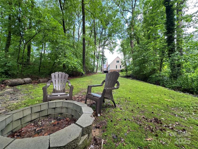 2437 Woodleigh Drive, Gastonia, NC 28056.  MLS# CAR4255182, YatesRealty ID 14250. Fire Pit looking back toward house from creek.