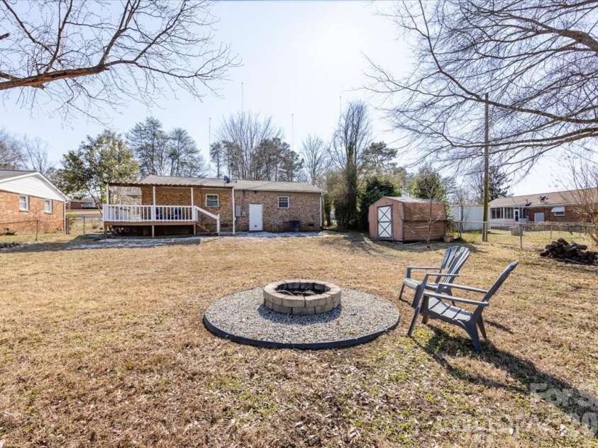 406 Robinson Clemmer Road, Dallas, NC 28034.  MLS# CAR4344855, YatesRealty ID 14265. Backyard features a firepit and storage shed
