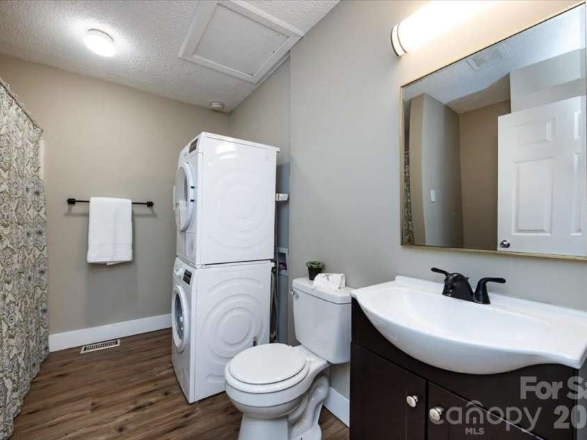 406 Robinson Clemmer Road, Dallas, NC 28034.  MLS# CAR4344855, YatesRealty ID 14265. Hall bath with updated vanity and light.  Stackable washer and dryer convey. 